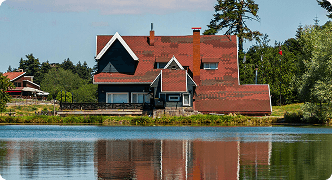 Cottage house near water representing cottage insurance coverage for vacation homes