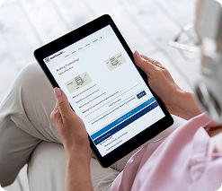 Customer reviewing personalized insurance solutions on tablet from home