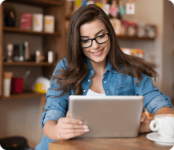 Woman using tablet to compare marine insurance and coverage options online